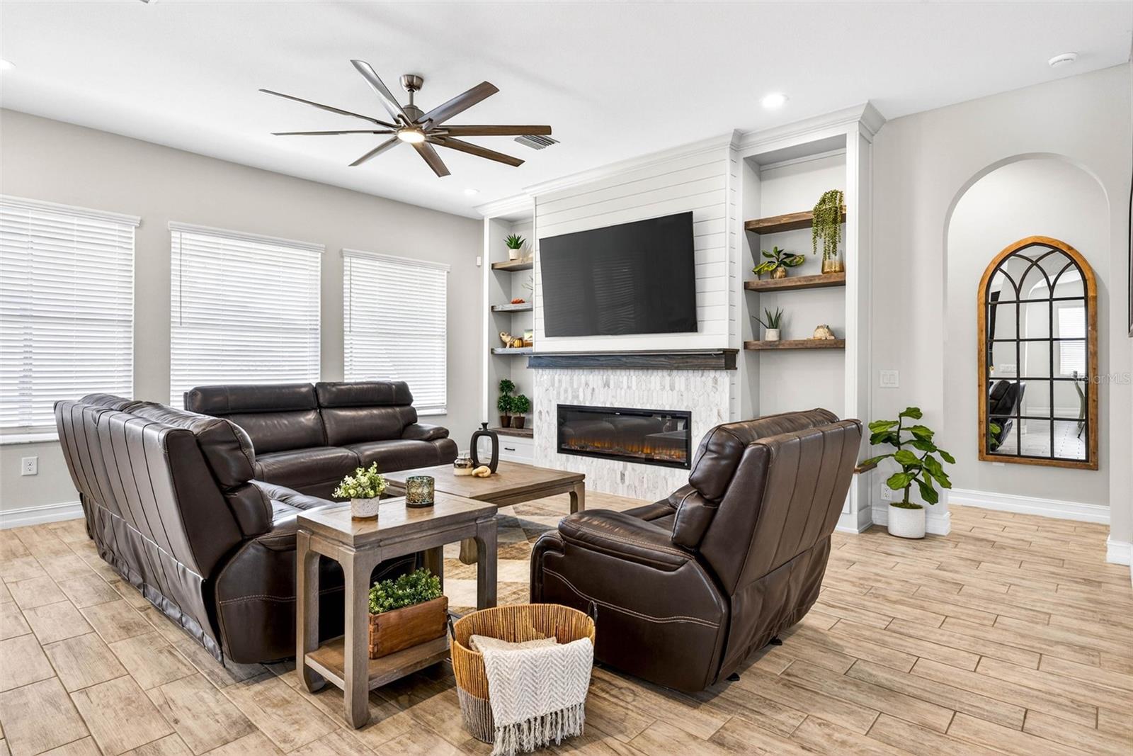 A built in entertainment center with electric fireplace becomes the centerpiece of the home.