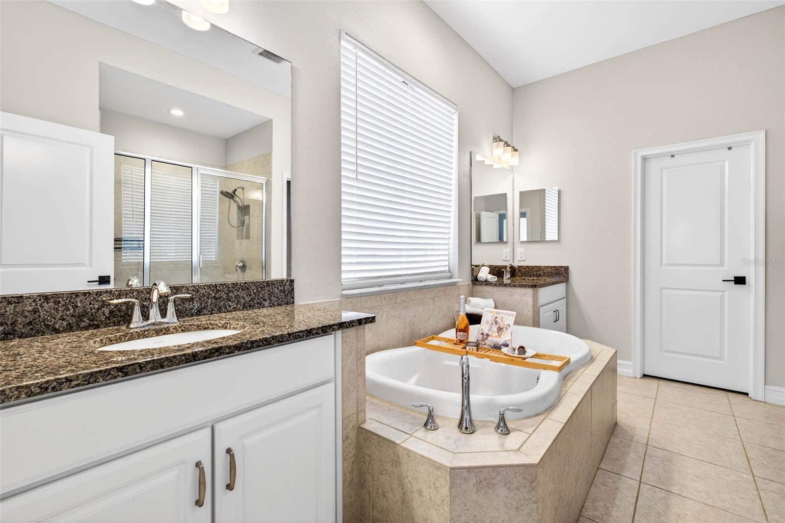 The ensuite bath has soaking tub, water closet, and walk in shower with 2 separate vanities.