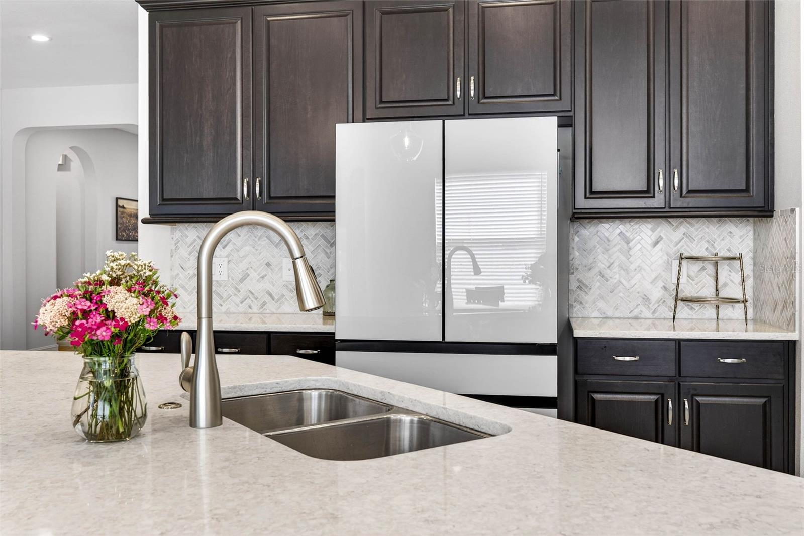 Quartz countertops throughout and 42" crowned cabinetry in your upgraded kitchen.