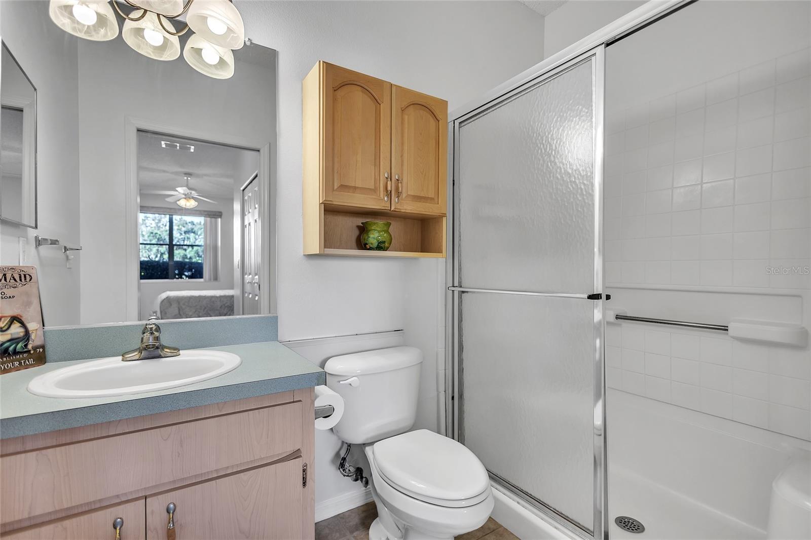 Ensuite bathroom with large shower with sliding glass doors.