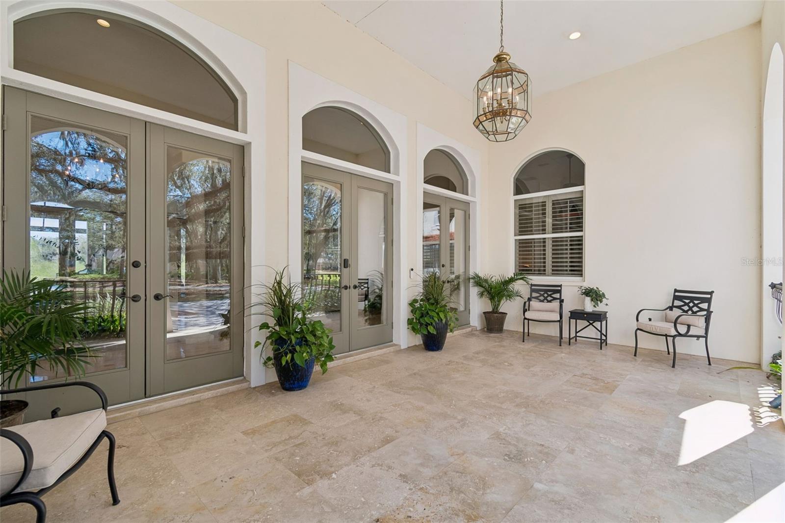 Beautiful Travertine Veranda with Trio of 11' French Doors
