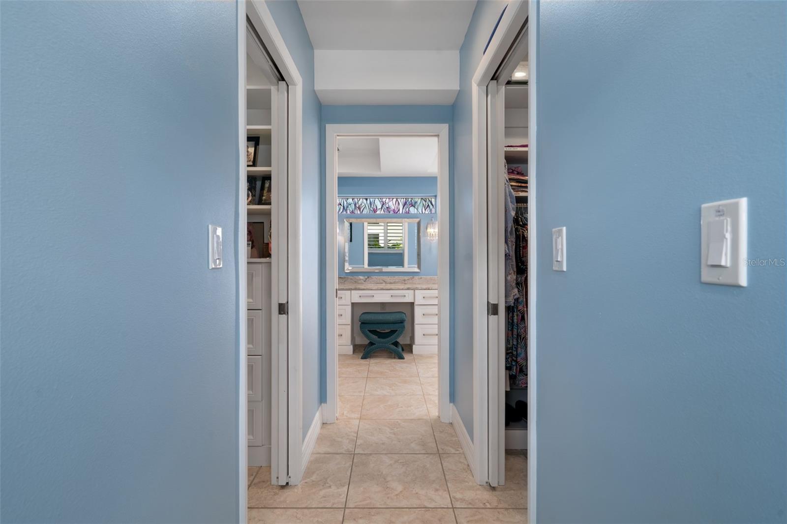 Primary suite with two custom walk-in closets