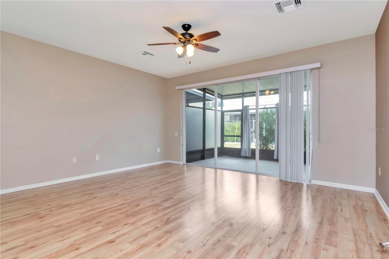 1st Floor Living Room Area view of Sliding Doors into Screened Lanai