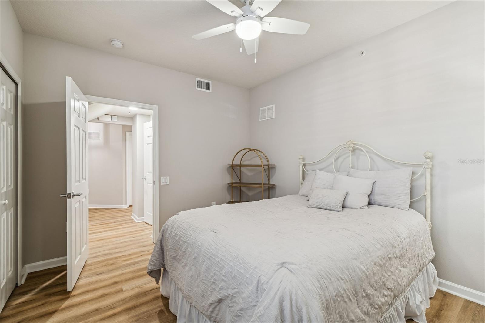 Spacious layout with double-door entry, ceiling fan, and warm-toned floors—ideal for comfort and function.