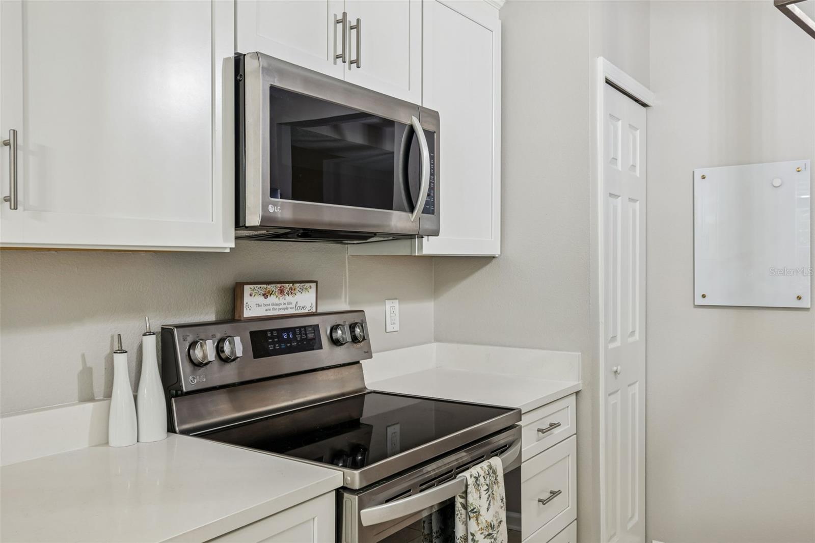 Cooking is a pleasure with a modern glass-top range, built-in microwave, and abundant cabinet storage.