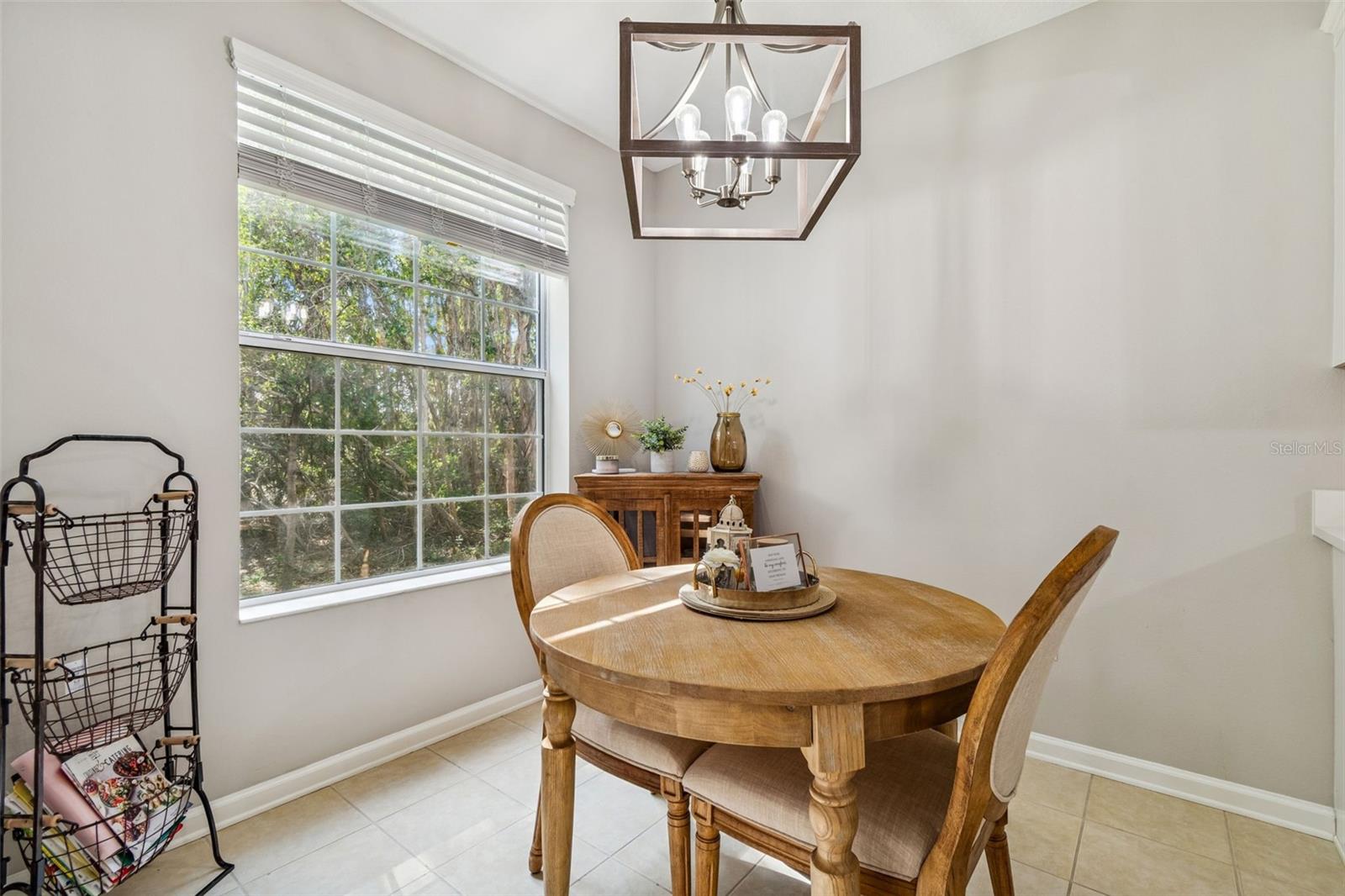 Enjoy your morning coffee in this inviting nook with picture window views of the serene backyard and conservation area.