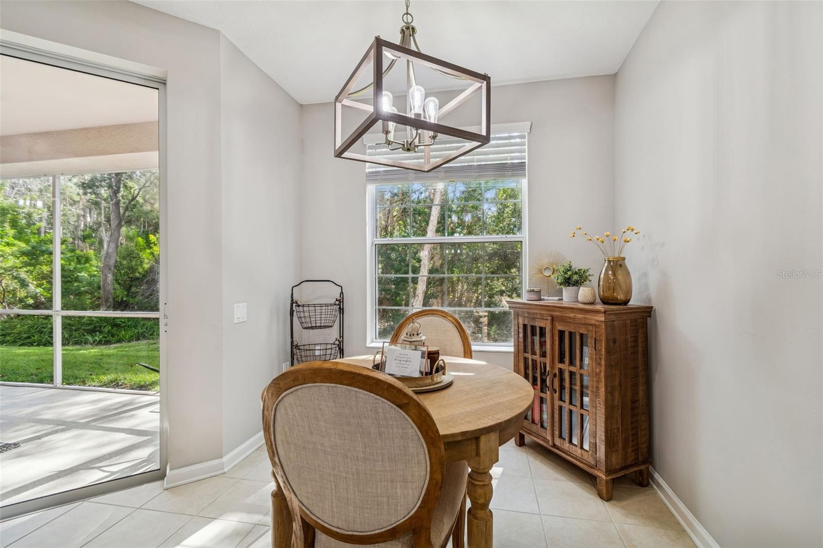 Cozy round dining space with direct access to the screened lanai—bringing nature just steps from your table.