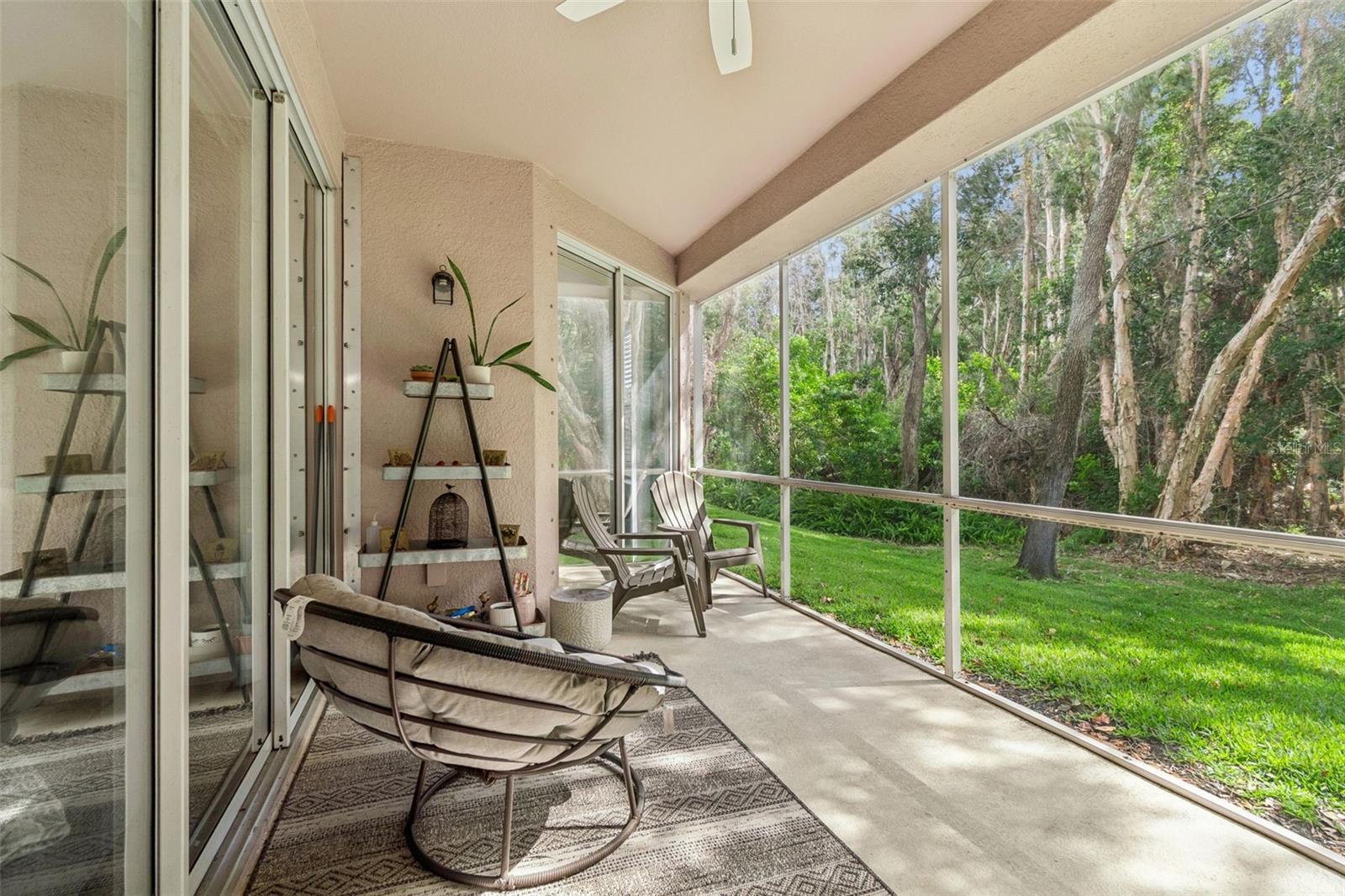 Just beyond the suite, step onto the screened-in patio — a quiet oasis surrounded by trees, perfect for morning coffee or evening breezes.