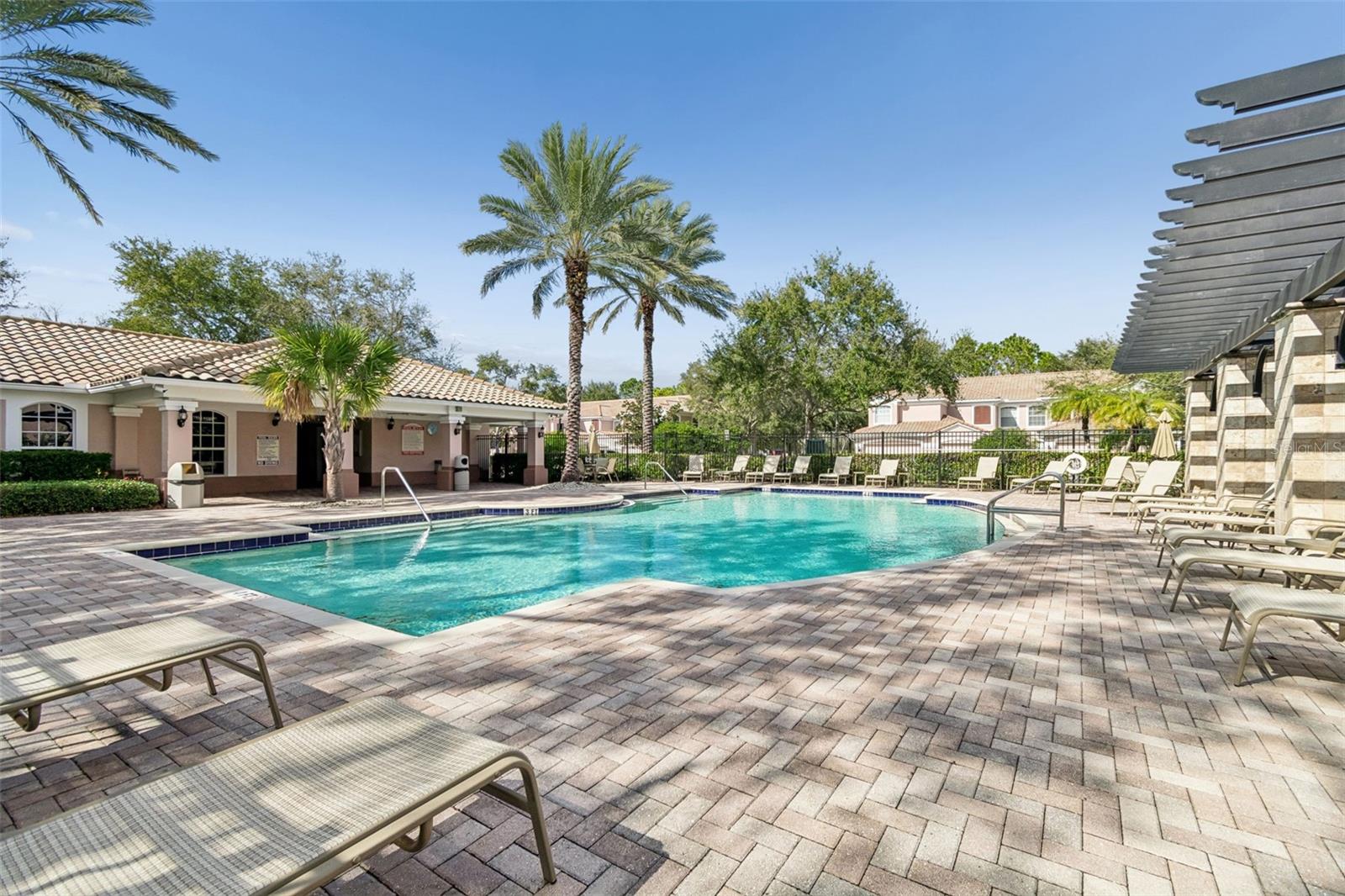 Offering a seamless blend of leisure and luxury, this curved-edge pool is surrounded by lush greenery and plenty of seating, ideal for morning laps or a peaceful afternoon soak.