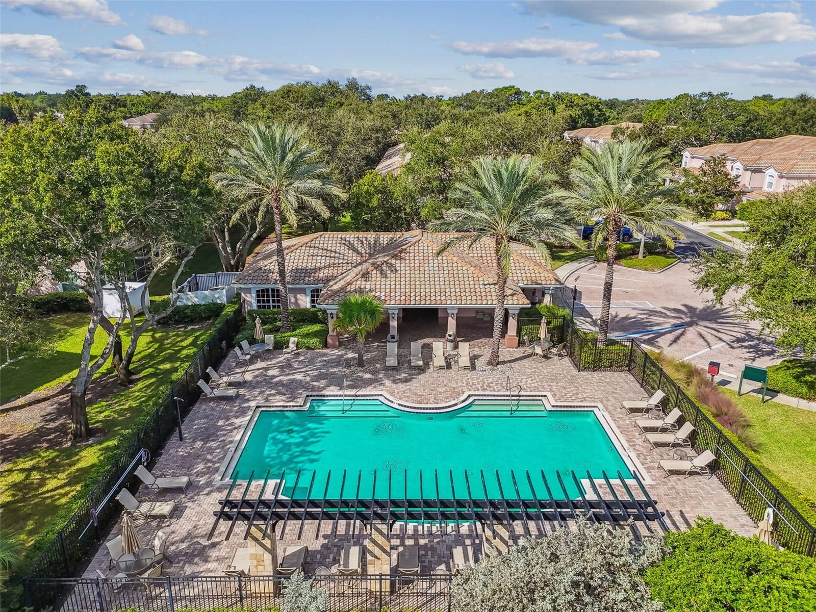 Enjoy the peaceful ambiance and abundant seating around this pristine community pool, ideal for soaking up the sun or cooling off with a refreshing swim.