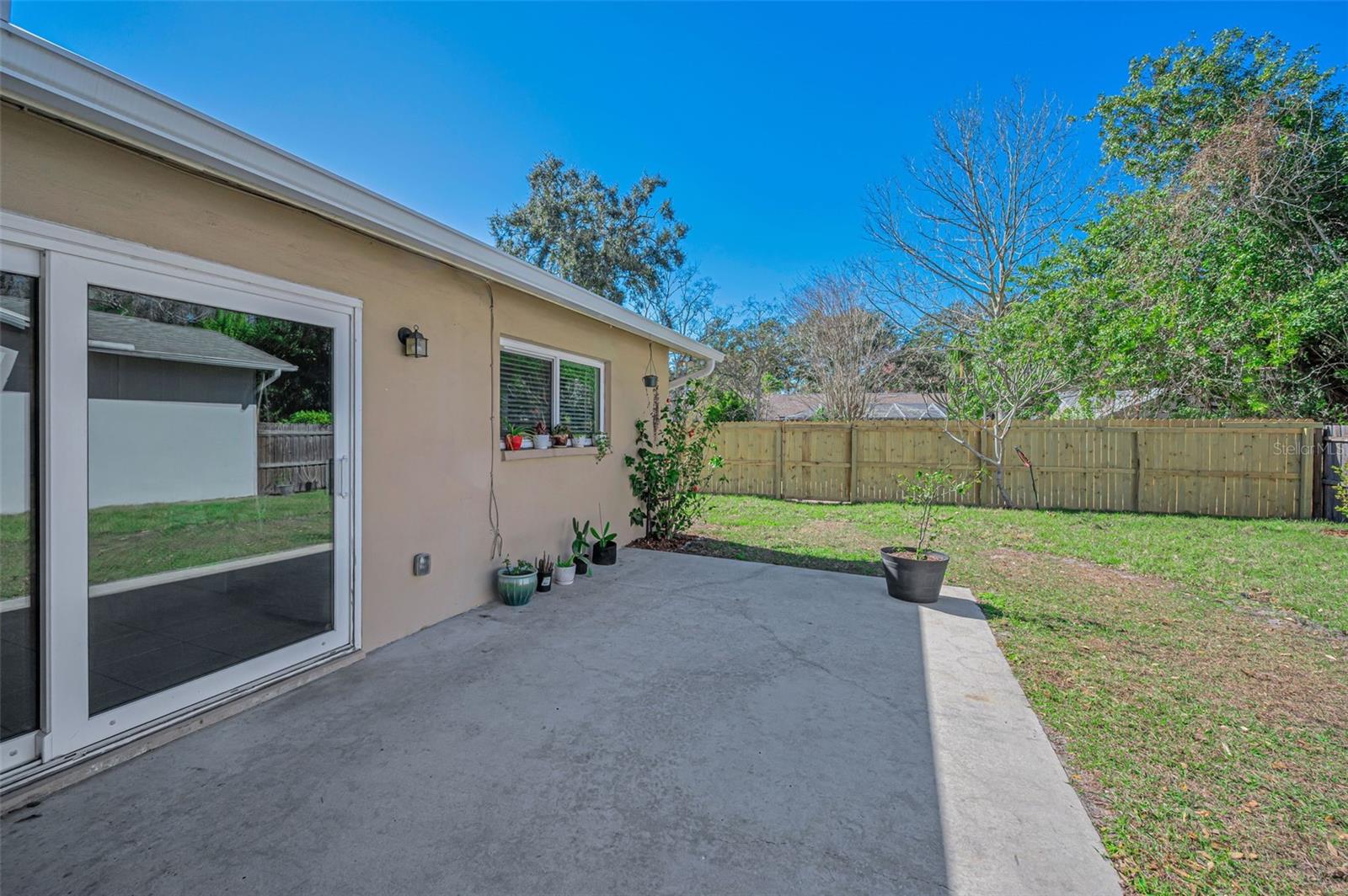 PRIVATE BACK YARD WITH NEW WOOD FENCE