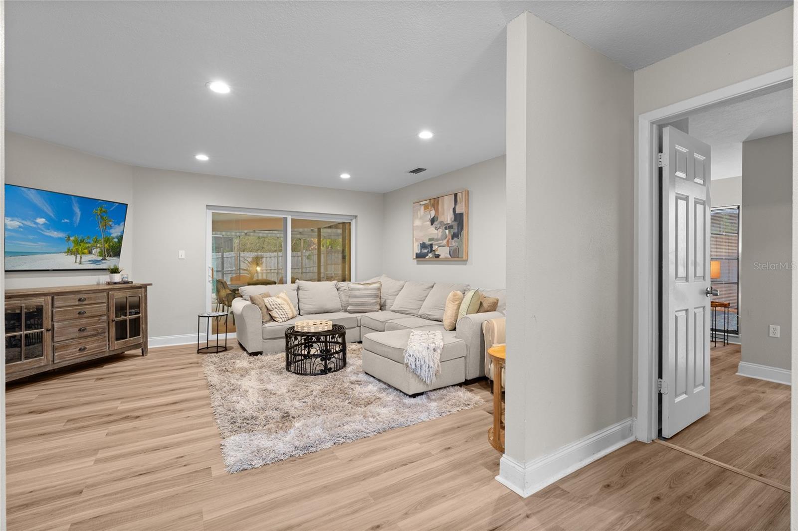Front Door facing Living Room ahead, 1st Primary Bedroom on the right