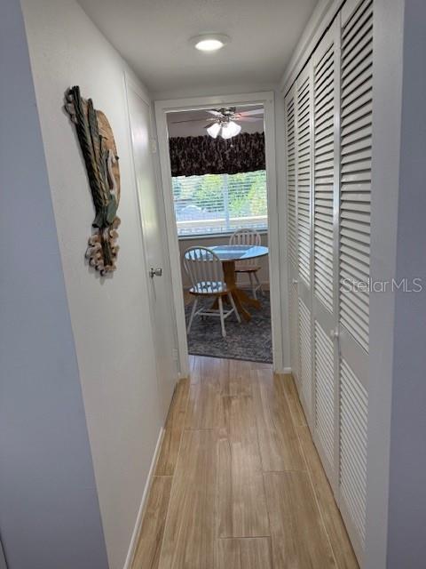 View From Kitchen Into Hallway Leading to Dining Area; Door on Left Leads to Half Bath; Door on the Rights Leads to Storage/Hot Water Heater