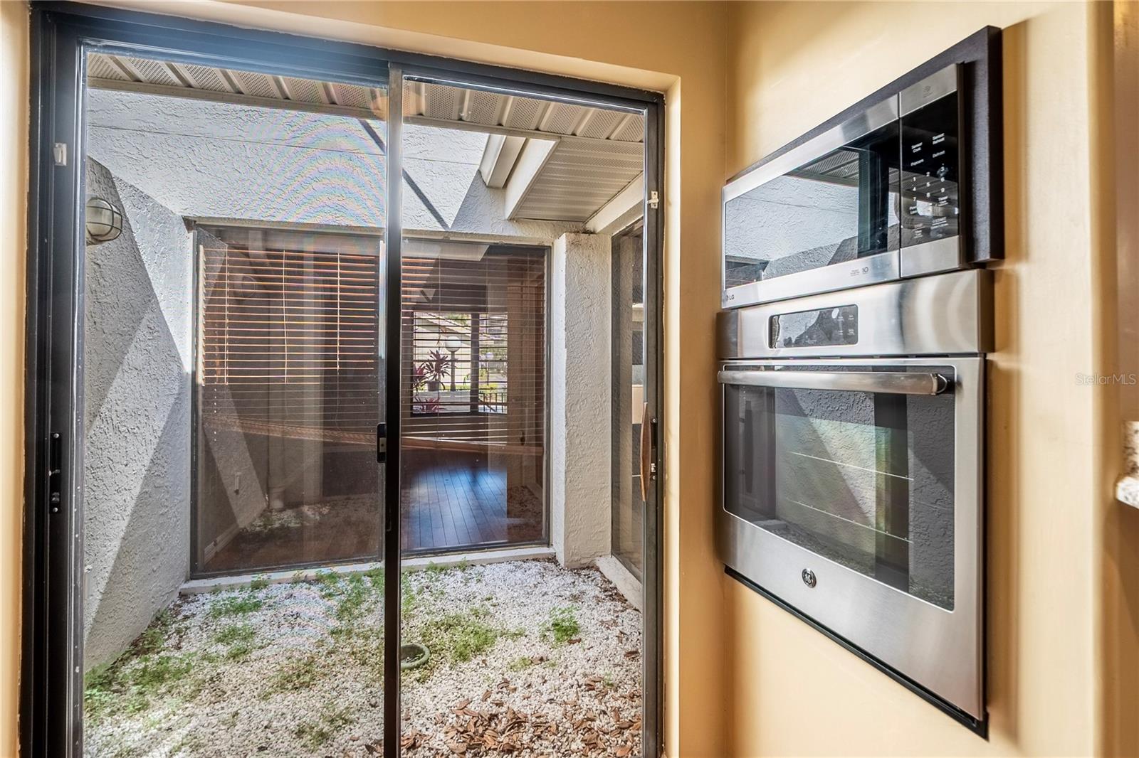 Glassed in atrium from kitchen looking toward the den/bonus room.