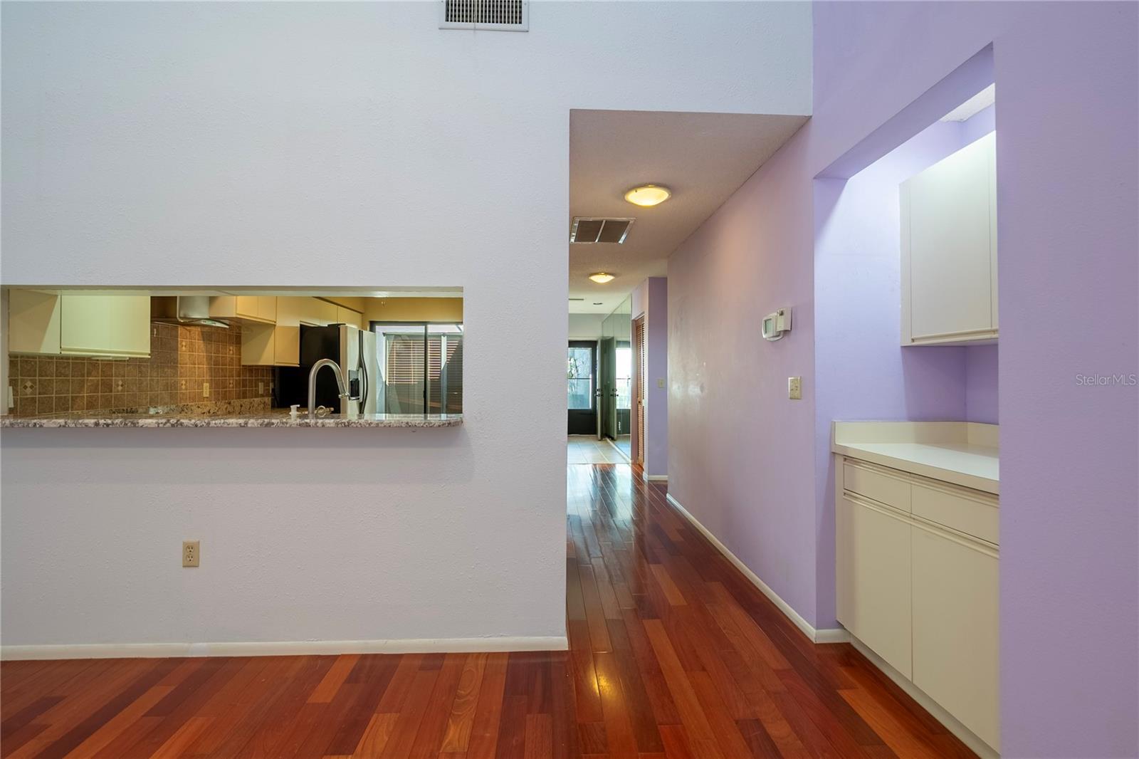 Dining room toward kitchen with dry bar on the right.