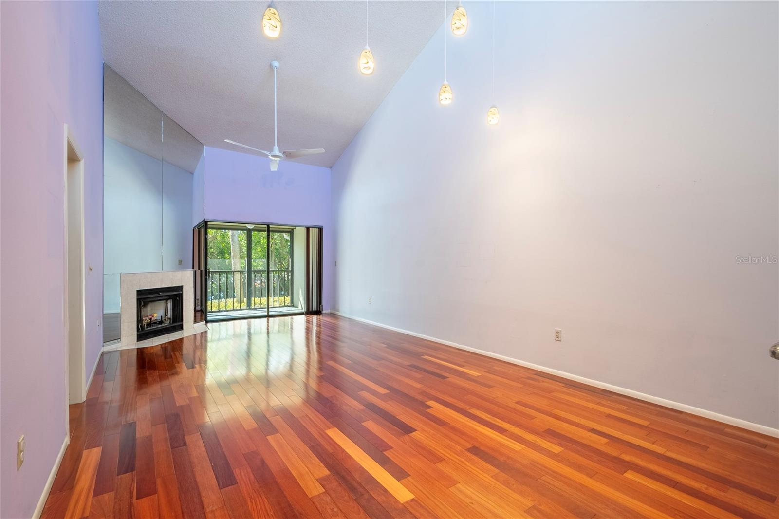 Spacious living room with high ceilings and leading to the screened lanai