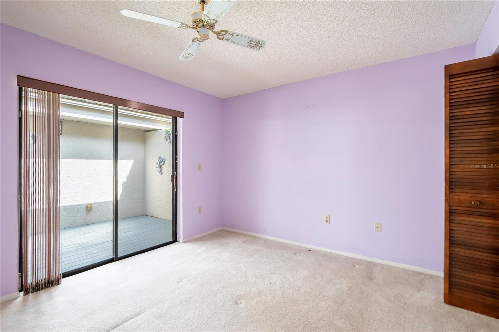 Guest bedroom opening onto private front patio