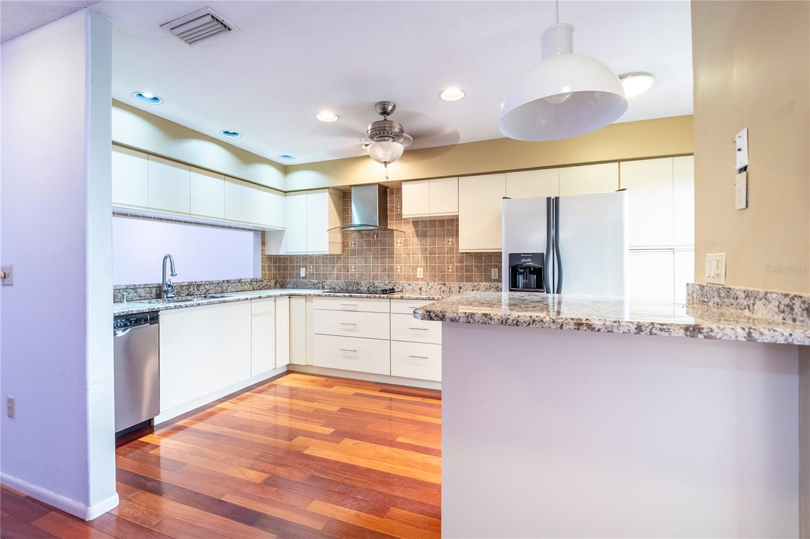 Kitchen with granite countertops and wood floors