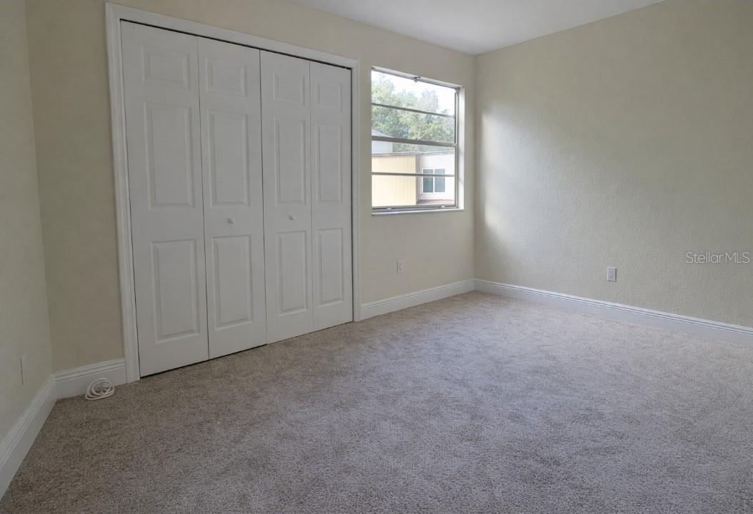 Upstairs bedroom 2. Built in shelving in all closets in the unit.