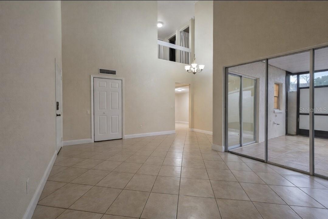 Living room looking towards entryway to kitchen/lower level bed/bath and landing