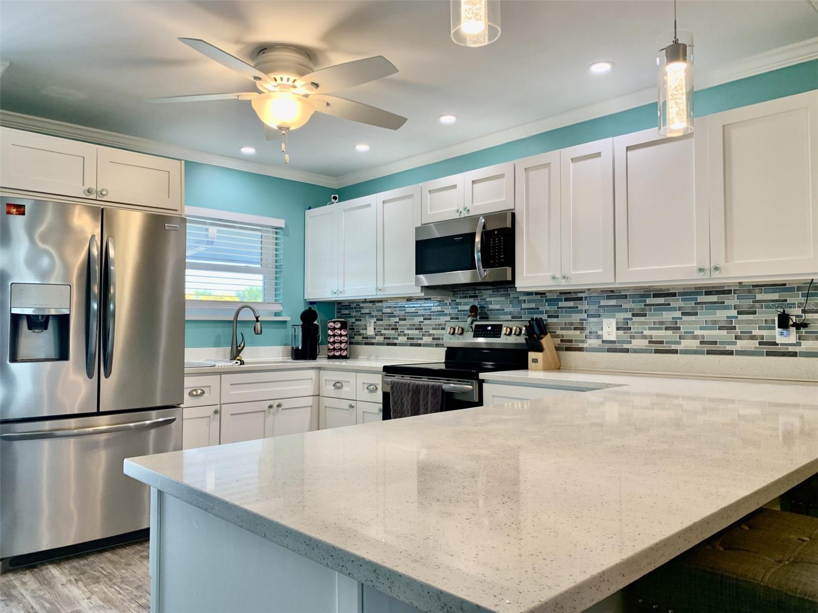Shaker cabinets, quartz counters and stainless appliances
