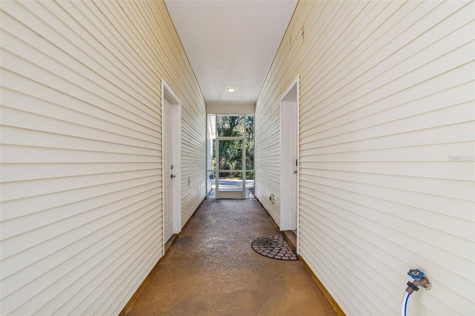 Hallway between Garage and rear entry to home.