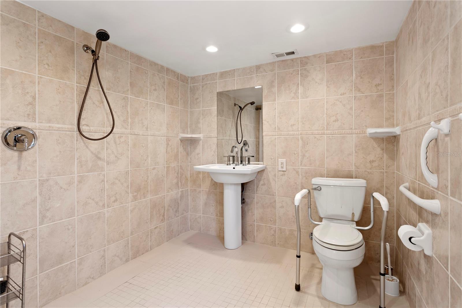 ADA wet room with roll in shower and grab bars