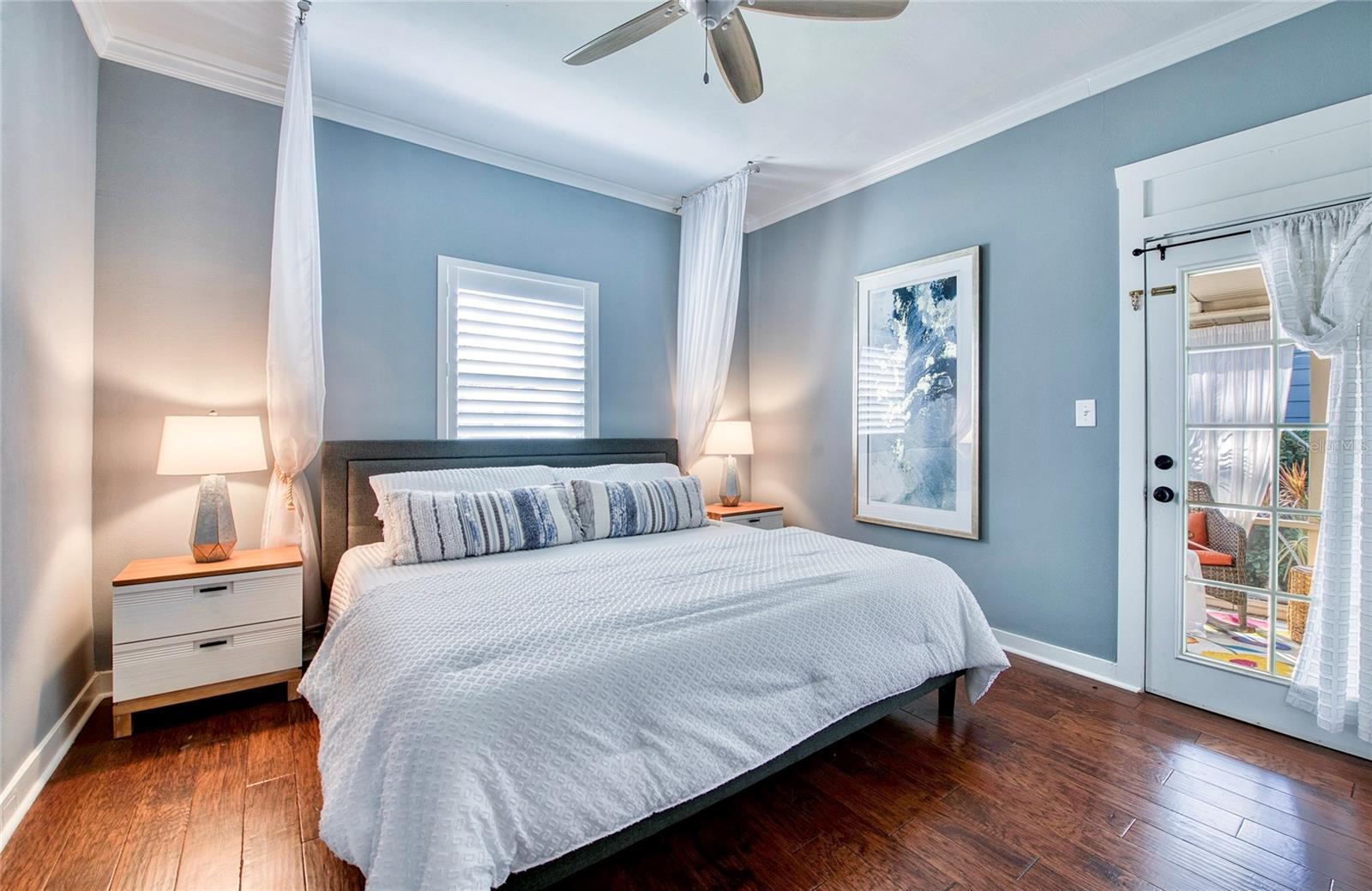 Step through the French door from the primary Bedroom onto a tranquil screened porch designed for relaxation