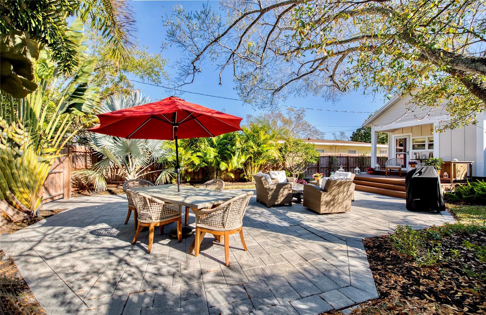 A private tropical patio sanctuary blends generous space with a sense of intimacy—ideal for sophisticated entertaining or a serene escape.