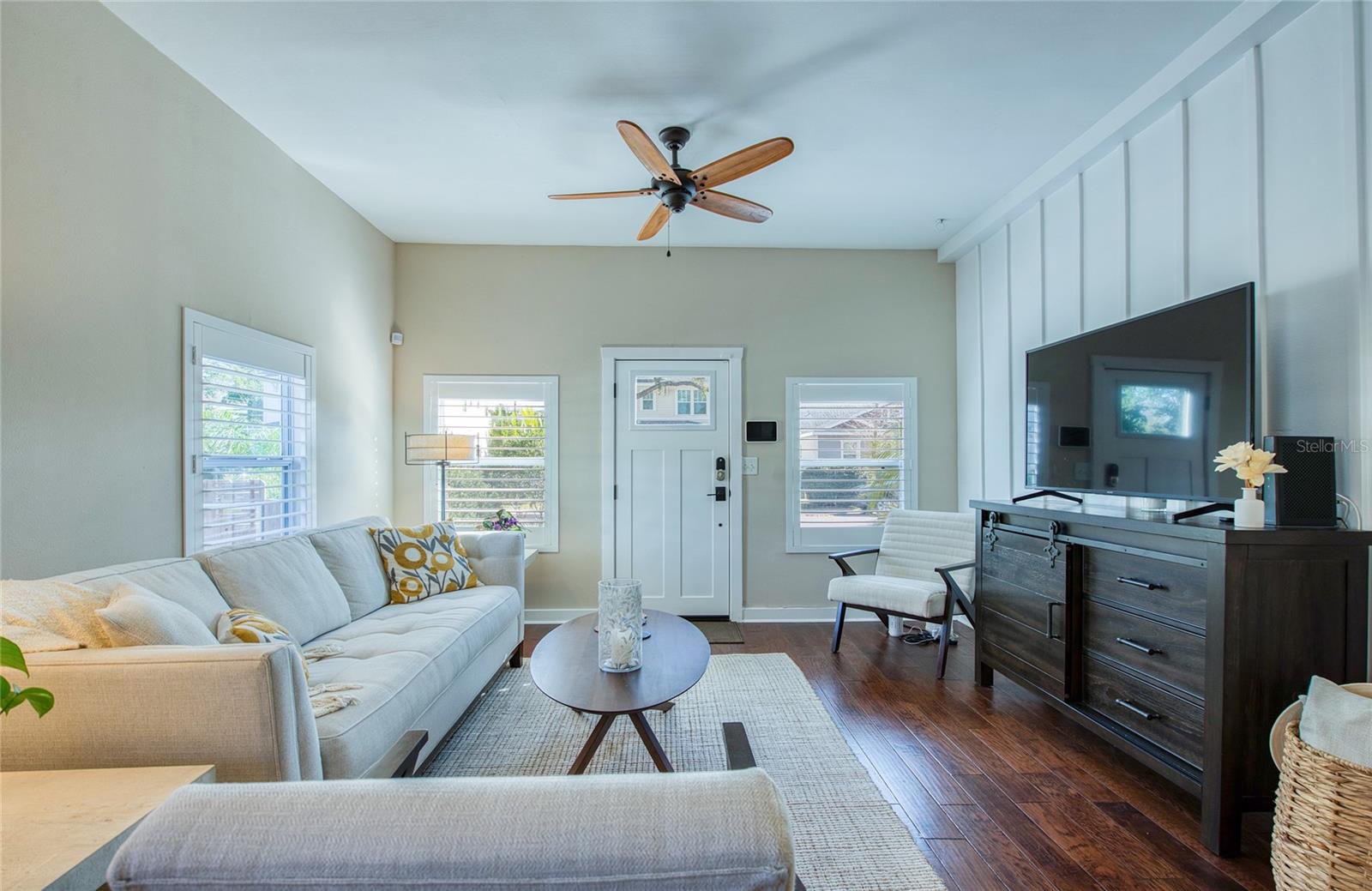 Charming board-and-batten accent wall enhances the living area’s inviting ambiance.