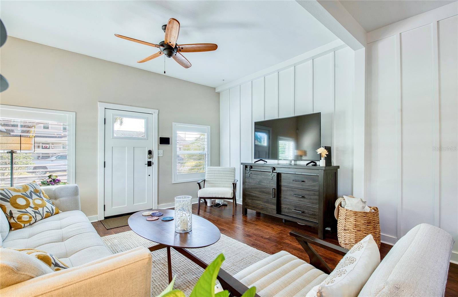 Beautiful warm wood floors extend through the living spaces and bedrooms, creating a cohesive, inviting feel.