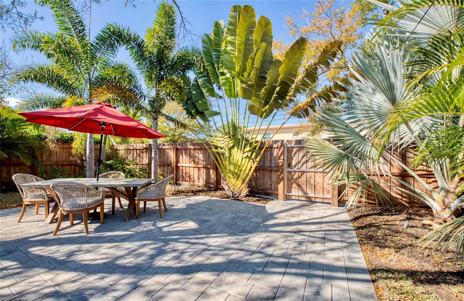 Prefossional landscaping surrounds the expansive pavered patio.