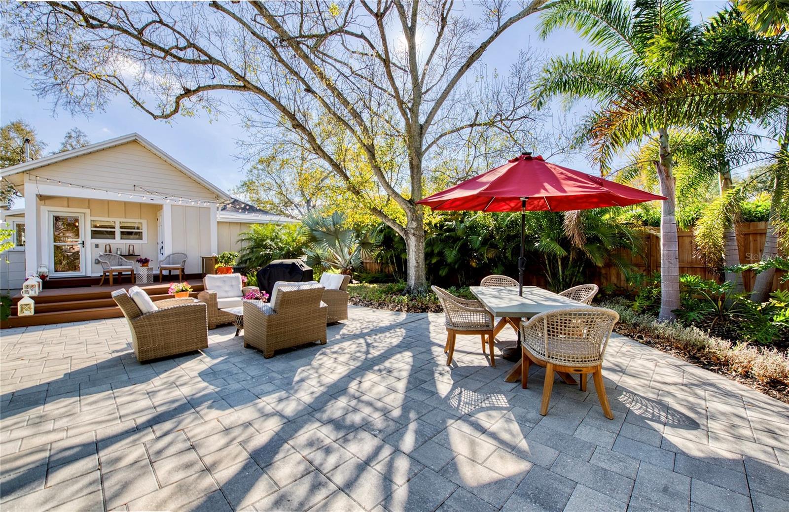 Dappled light streams through the tree that perfectly frames the yard.