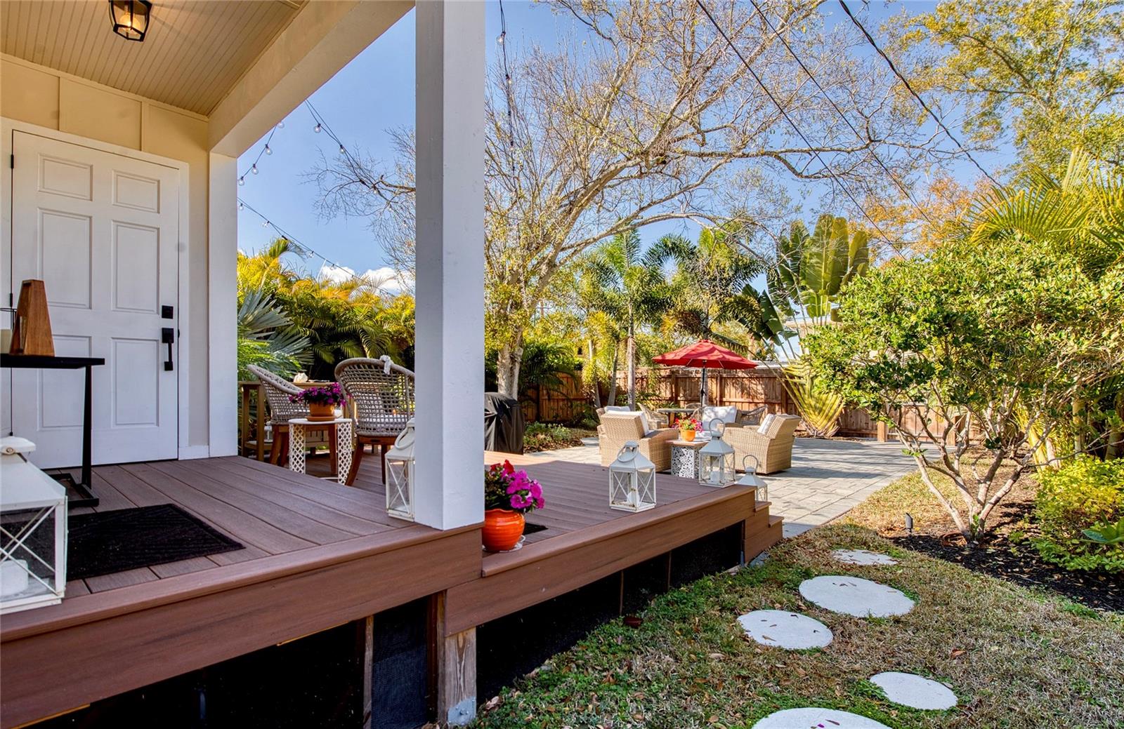 Laundry room is on the shaded sun-porch and conveniently located just outside the back door.