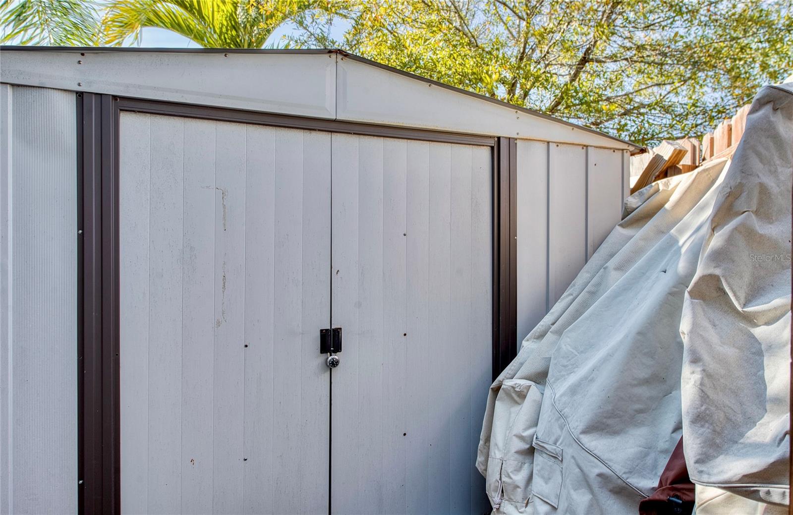 Large storage shed: perfectly hidden in back yard & so convenient.
