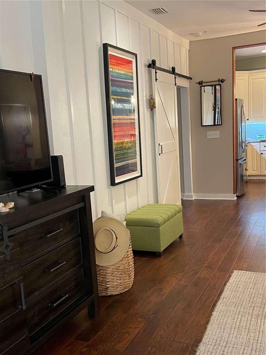 Thoughtful details in the living room include a stylish barn door and timeless board-and-batten accents.