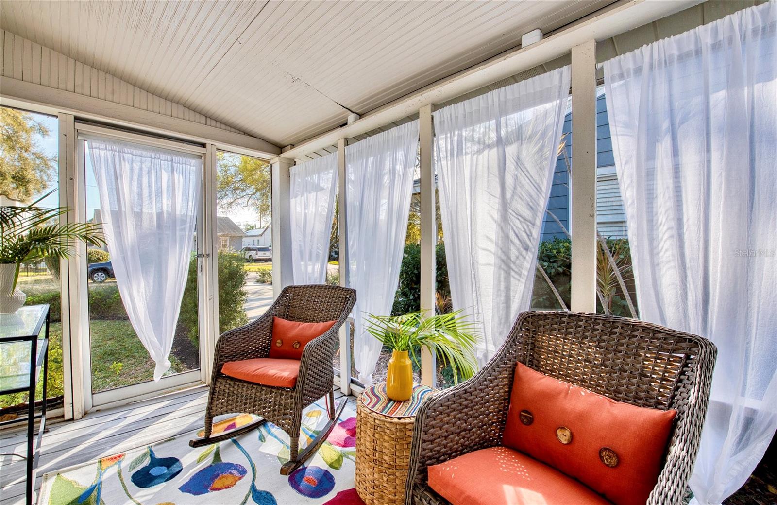 French door leads from the primary bedroom into a spacious side porch — almost 200 square feet of bonus space to relax and unwind.