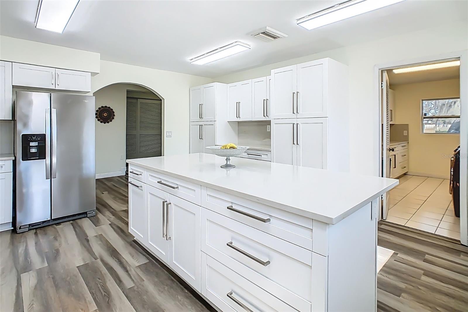Updated cabinetry and expanded workspace with updated flooring