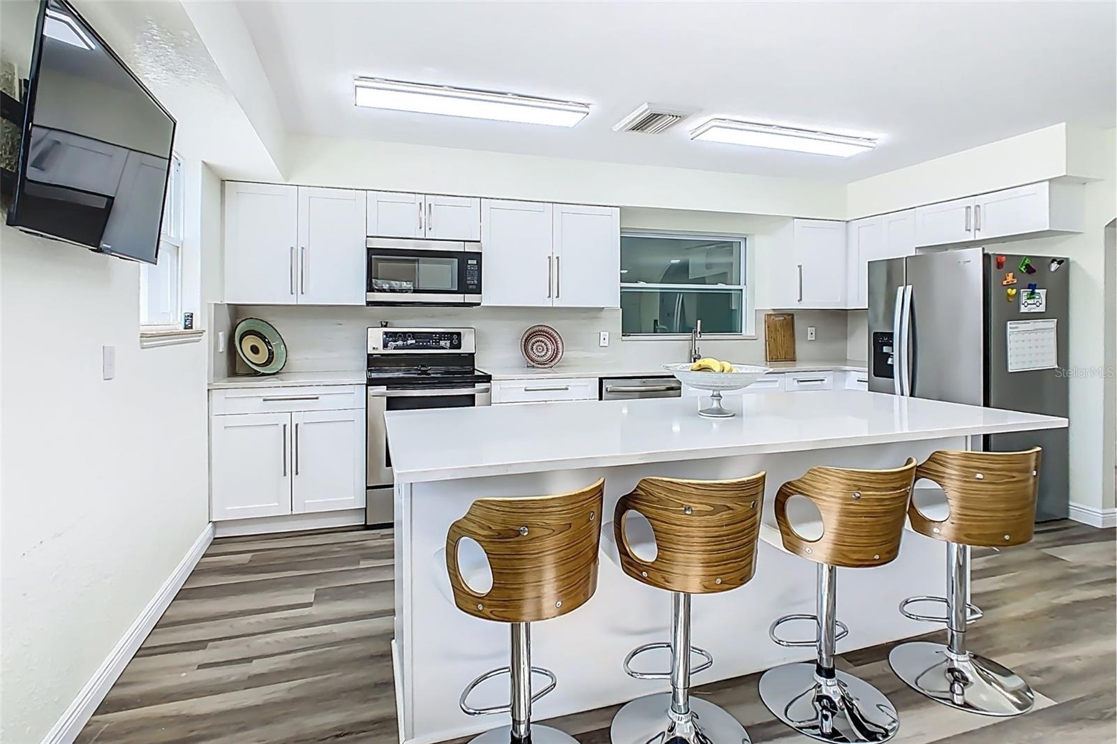 Open-concept kitchen with oversized island and updated layout