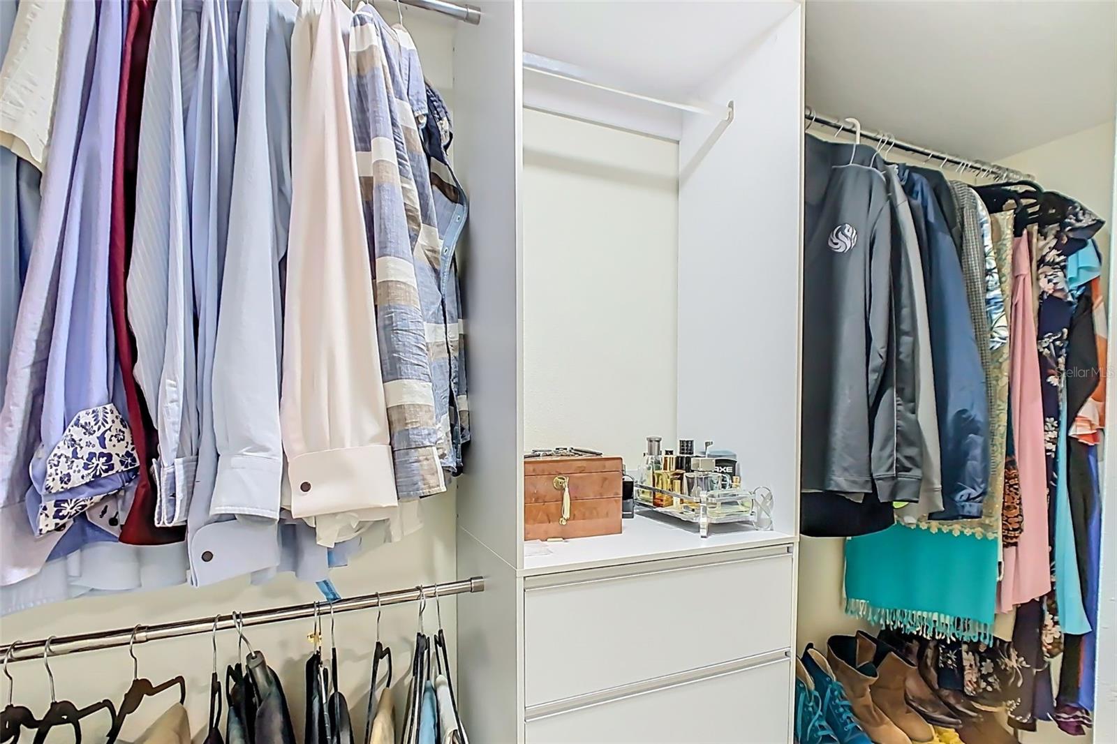 Primary walk-in closet with custom built-in storage