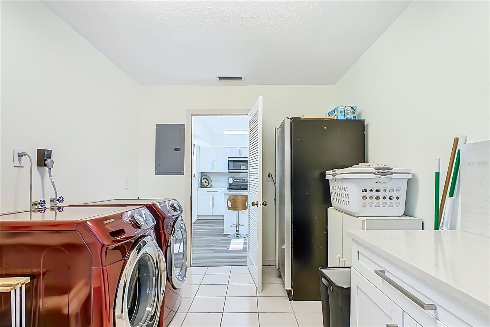 Renovated laundry room with updated cabinetry and workspace