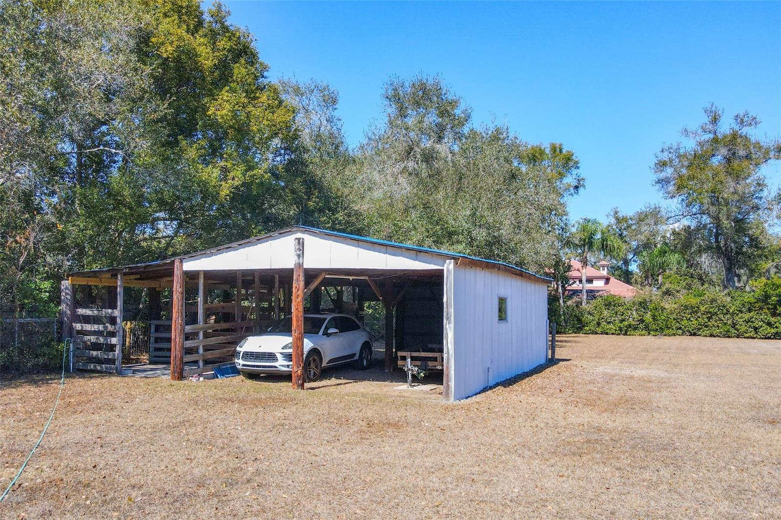 Interior view of barn configured for vehicle storage or equipment.