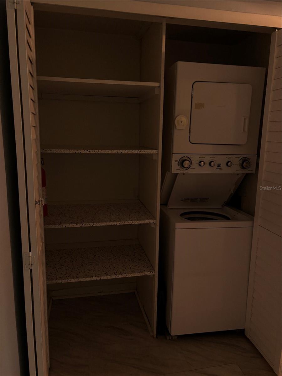 Large kitchen pantry and stacked washer & dryer