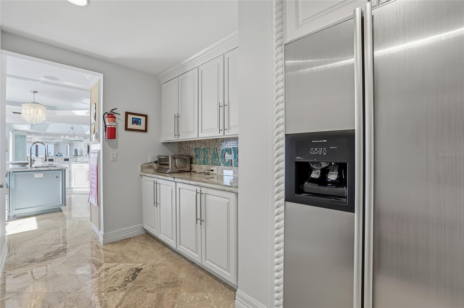 Butler's pantry with walk-in storage, spare fridge and in-unit trash chute