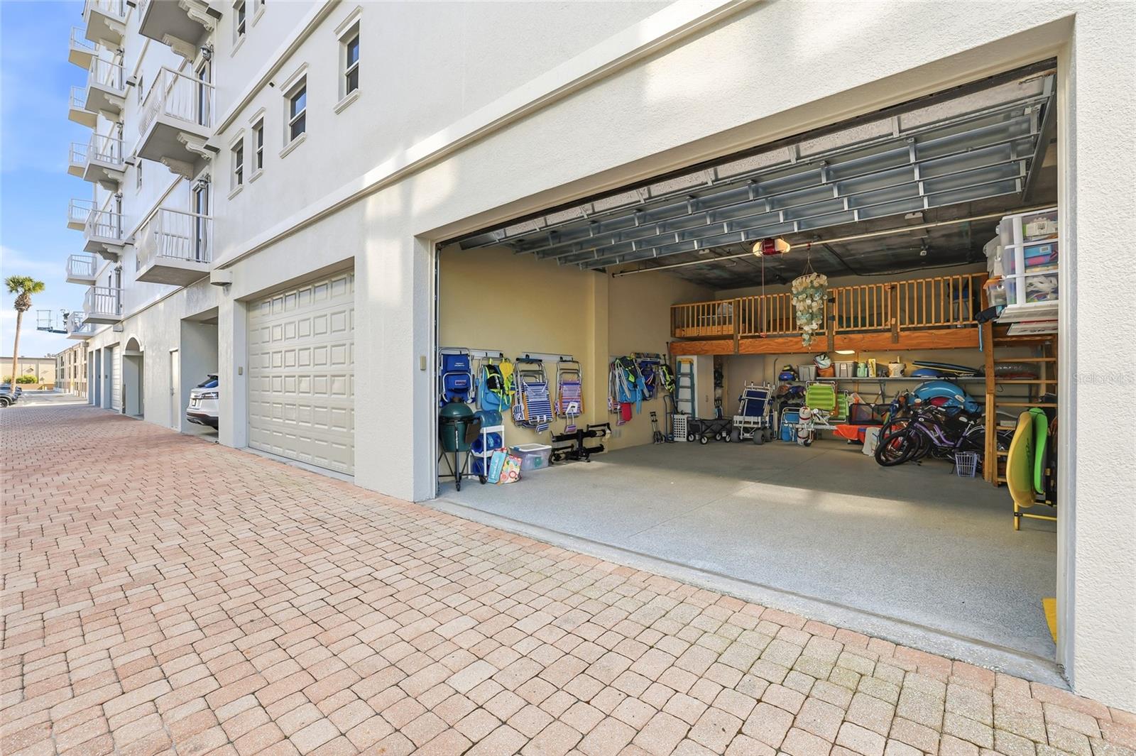 The unit's private garage has covered walkways all the way to the unit