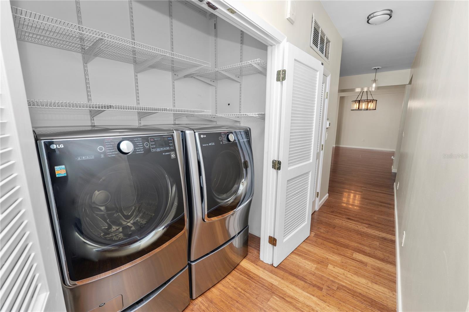 Laundry closet with washer and dryer included.
