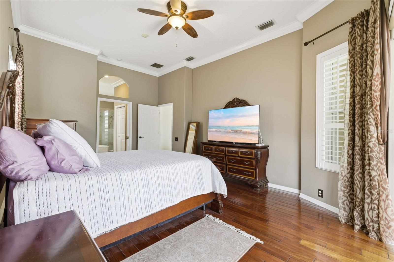 Primary suite with mahogany wood floors.