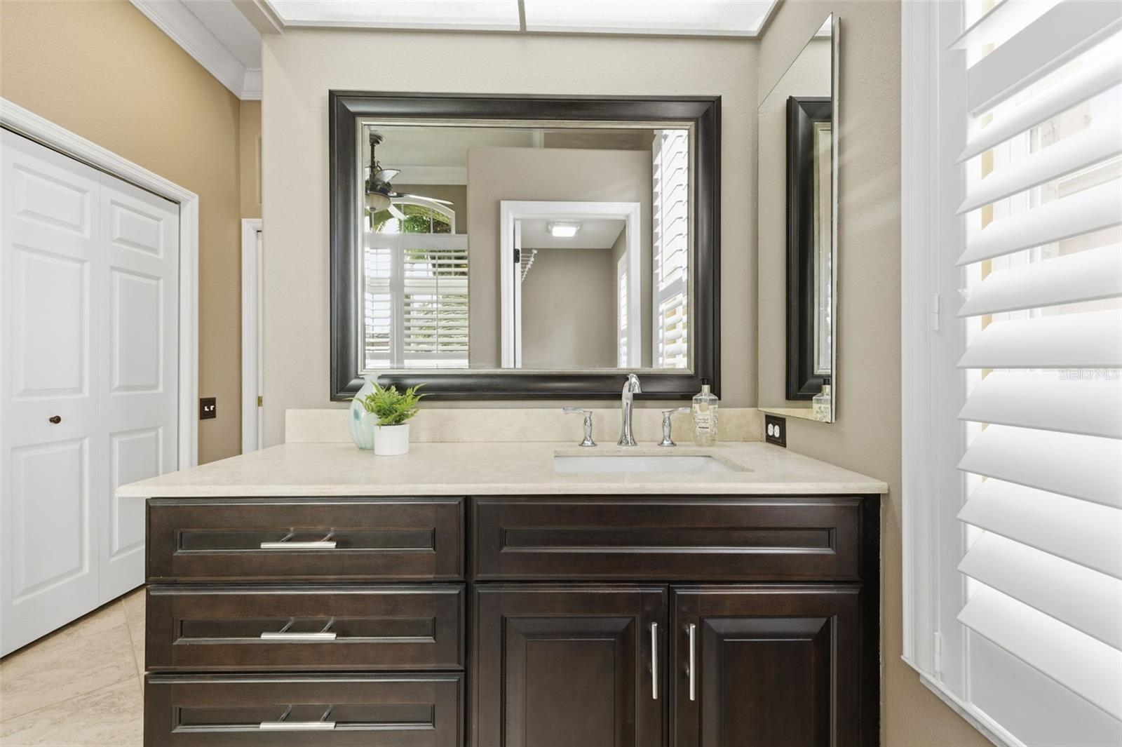 Remodeled primary suite with custom dual vanities.