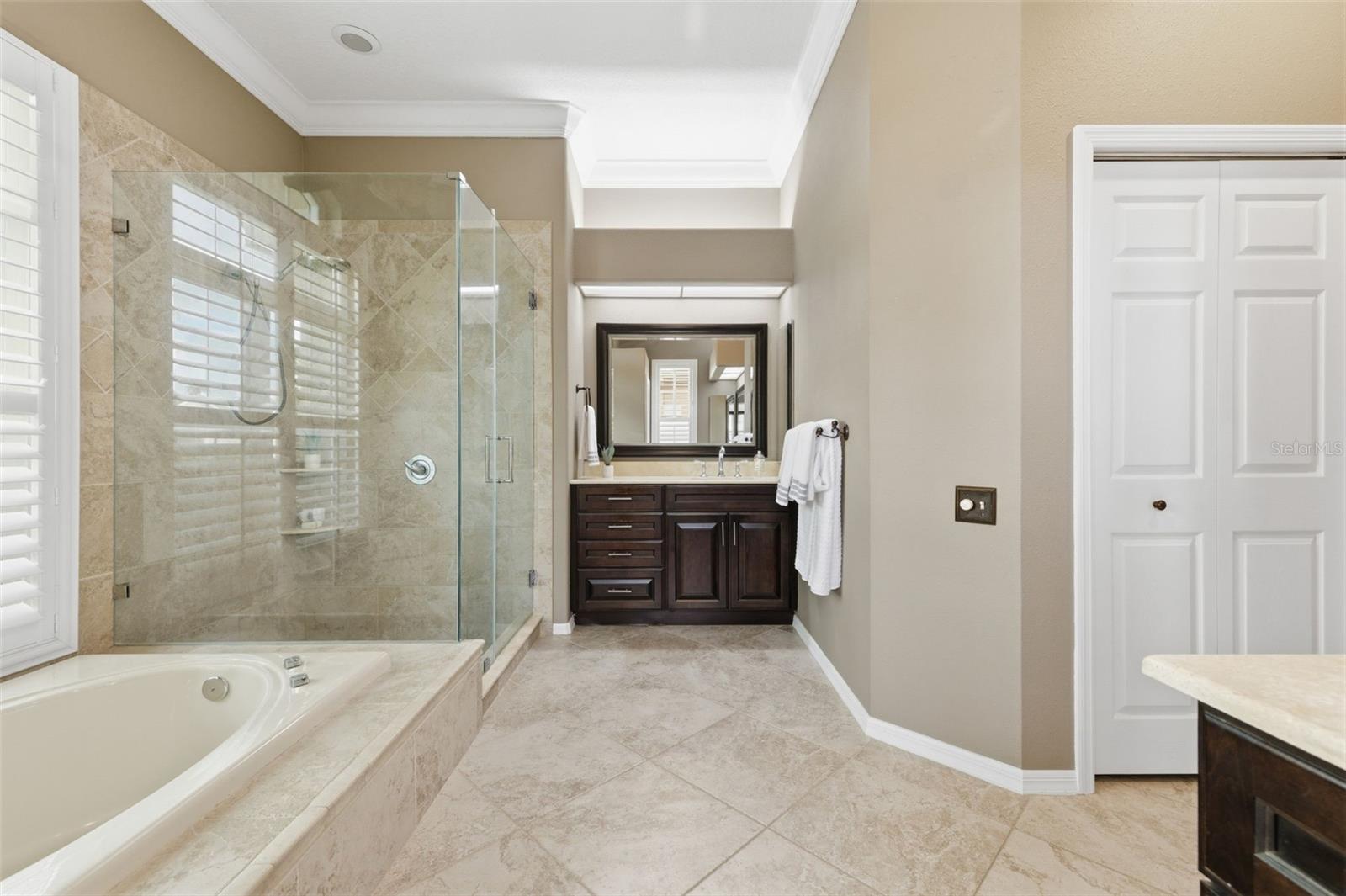 Remodeled primary suite with travertine counter tops.