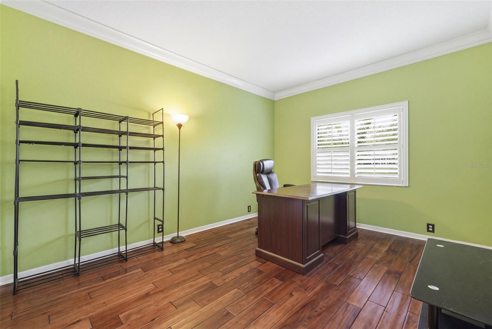 Guest bedroom 2 with mahogany wood floors.